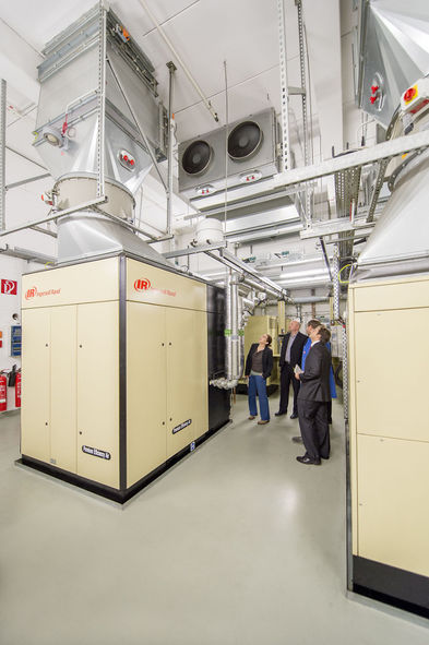 Fachbesucher im Werk Gütersloh lassen sich die Funktion einer Druckluftanlage mit Abwärmenutzung erklären.